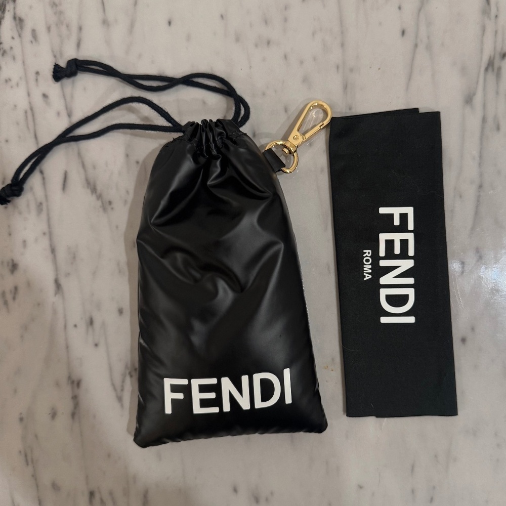 Fendi puffy drawstring accessory bag with brass clip, like new, 8” x 4”